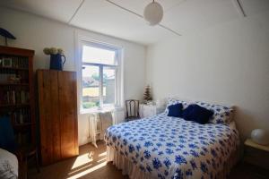a bedroom with a bed and a window at Captains Cottage in Deal