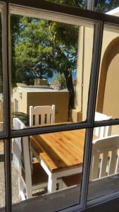 a view of a table and chairs from a window at Twin Palms Accommodations in Mossel Bay