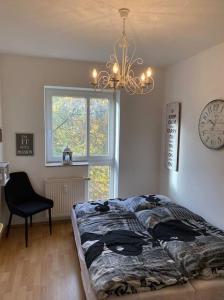 a bedroom with a bed and a clock on the wall at 4 Zimmer Wohnung mit 6 Betten nahe Hamburg in Glinde