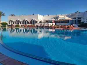 a large swimming pool in front of a hotel at Uni sharm aqua park in Sharm El Sheikh