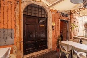 a wooden door in a building with a table and chairs at Luxury Trastevere in Rome