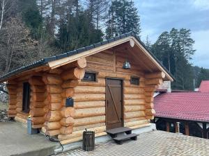 a log cabin with a door on it at Q Chalet in Săcele