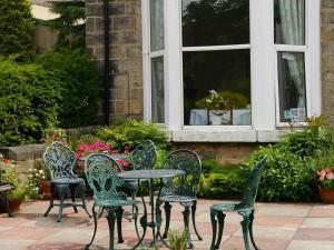 a group of chairs and a table in front of a window at Conference View Guest House in Harrogate