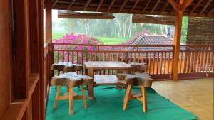 a porch with a table and chairs on a balcony at Provok bungalows in Sangyang