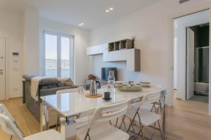 a kitchen and living room with a table and chairs at Casa 7 Mari - BARI Fiera del Levante - Puglia Apartments in Bari