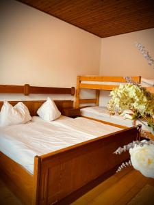 two bunk beds in a room with flowers on the floor at Pension Gartner in Wallern im Burgenland