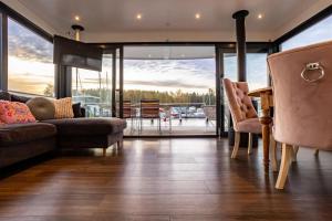 a living room with a couch and a table at Schwimmendes Haus - Hausboot Paradise in Peenemünde