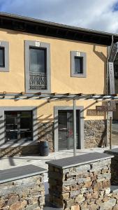 a building with a bench in front of it at Hotel Cadario 1925 in Tebongo