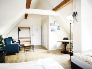 a living room with white walls and a blue couch at Rock-inn in Rokytnice nad Jizerou +82 photos