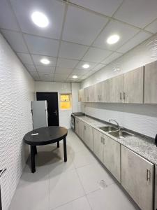 a kitchen with a sink and a table in it at Economic rooms for rent in Dubai in Dubai