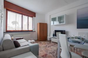 a living room with a couch and a table at Tirrenia Cozy Apartment near the Beach in Tirrenia