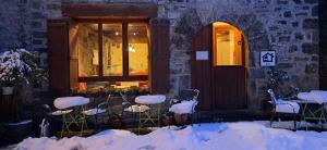 a building with snow covered chairs in front of a door at Tetxe B&B Roncal in Roncal