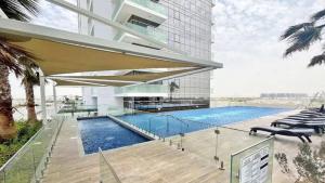 a rendering of a building with a swimming pool at Tanin - Studios at Damac Hills Carson Tower C in Dubai