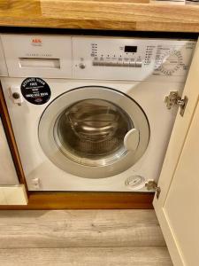 a washer and dryer in a cabinet in a kitchen at Casa Kerr @ The Broch in Perth