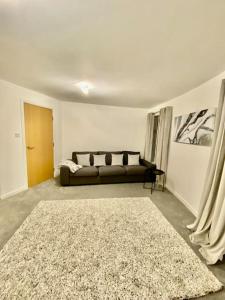 a living room with a couch and a rug at Casa Kerr @ The Broch in Perth