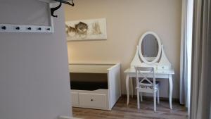 a bathroom with a dressing table and a mirror at Penzion Valkoun-Lilienfeld in Karlovy Vary +44 photos