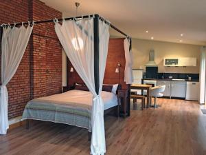 a bedroom with a bed and a brick wall at die schmiede in Burg auf Fehmarn
