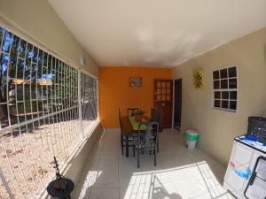 a room with a balcony with a table and chairs at Resident Emiterio in Blue Bay