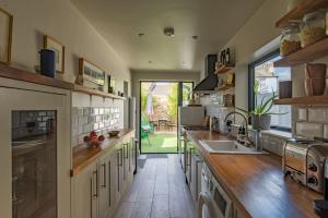a large kitchen with wooden counters and a large window at Rosewood in Walmer