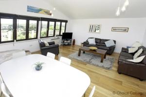 a living room with a table and a couch at CROYDE ILUKA 3 Bedrooms in Croyde