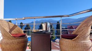 a pair of wicker chairs with a coffee pot on a table at CERULEAN RETREAT in Lava