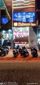 a group of motorcycles parked in front of a building at Hotel Shivam Inn Party Palace By WB Inn in Agra