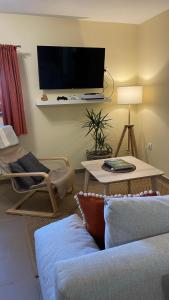 a living room with a couch and a tv at Górskie Zacisze in Zawoja