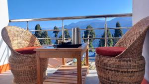 a table and chairs on a balcony with a view at CERULEAN RETREAT in Lava