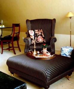 a living room with a chair and a coffee table at Lütt Wieck App Nr 12 in Wieck +1 photo