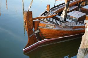a wooden boat sitting in the water at Lütt Wieck App Nr 12 in Wieck