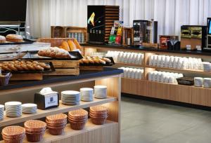 a bakery with plates and breads on display at Wellness Hotel Svornost in Harrachov