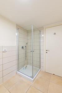 a shower with a glass door in a bathroom at Cosy & Calm Central Getaway Modern Guest Suite by Midrachov 1 Queen Bed in Zikhron Ya‘aqov