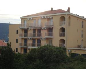 a large building with balconies on the side of it at Apartments LUX Milano, Savina,Herceg-Novi in Herceg-Novi
