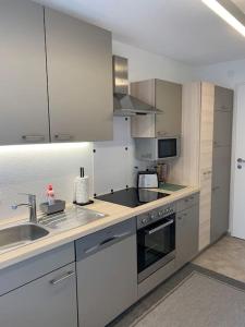 a kitchen with a sink and a stove top oven at Gemütliche Wohnung mit guter Anbindung in Thaur