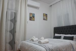 Ένα ή περισσότερα κρεβάτια σε δωμάτιο στο Sarakina City