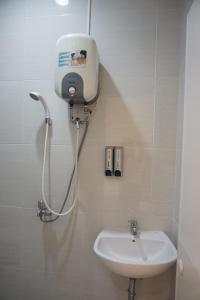 a bathroom with a shower and a sink at Aurora House Surabaya in Wijung