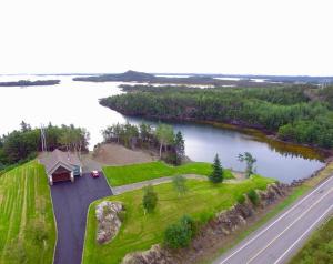 an aerial view of a house next to a lake at The Millhouse Oceanfront Cottage in Summerford