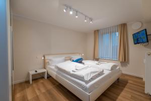 Postel nebo postele na pokoji v ubytování Ostseevilla - Appartement 05