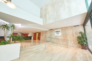 a lobby with a staircase in a building at DWO Sirius - Adults Only in Santa Susanna