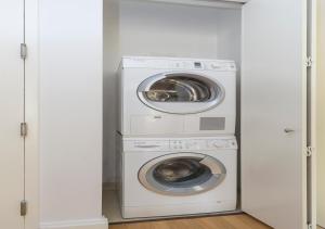 a washer and dryer in a white laundry room at Fantastic 3BR At Financial District in New York