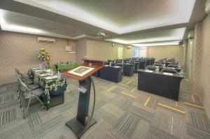 a conference room with tables and chairs and a podium at Arenaa Batik Boutique in Kuantan