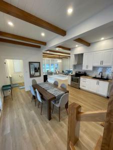 a kitchen and dining room with a table and chairs at The Millhouse Oceanfront Cottage 