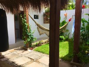 a view from the outside of a house with a hammock at Recanto de Maragogi in Maragogi