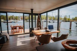 a home office with a table and a laptop on it at Schwimmendes Haus - Hausboot Trinity in Peenemünde