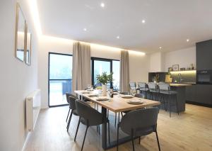 a dining room and kitchen with a table and chairs at VIlla Luka - new isolated villa with heated pool, jacuzi and sauna in Gračac