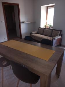 a living room with a table and a couch at Ca' di Burghi 2 in Busca +3 photos