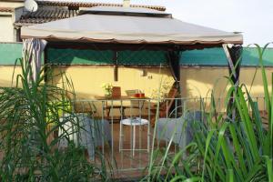 a gazebo with a table and chairs at Luigi Apartments&Rooms in Pula
