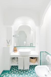 a bathroom with a sink and a mirror at Hotel Cetus in Cetara