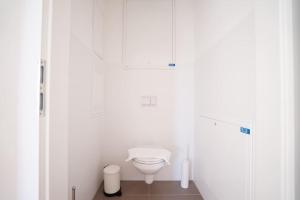 uma casa de banho com WC num quarto branco em Apartment with terrace near Metro Station and Spa em Viena