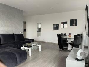 a living room with a couch and a table at 4 Room Penthouse Terrace W18+W19 in Bucharest